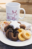 Plate of biscuits in front of a Christmassy mug