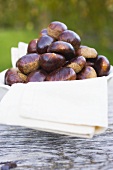 Chestnuts on cloth in white bowl