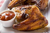 Grilled chicken wings with ketchup (close-up)