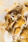 Remains of roast chicken on paper