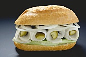 Herring, onions and gherkins in bread roll