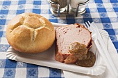 Leberkäse with bread roll & mustard on paper plate
