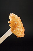 A chicken nugget on a wooden fork