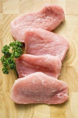 Several slices of pork fillet with parsley