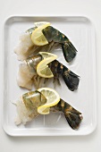 Fresh king prawns with lemon slices on tray