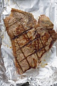 Grilled T-bone steak on aluminium foil