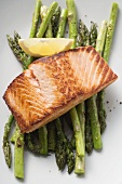 Fried salmon fillet on green asparagus