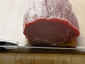 Beef fillet on chopping board with knife