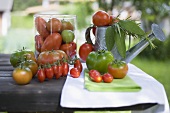Various types of tomatoes on table out of doors