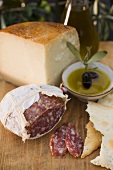 Salami, crackers, olives, olive oil and Parmesan