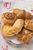 Sweet pastries on doily in wire basket