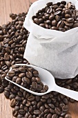 Coffee beans, in and around sack, and scoop