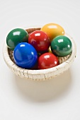 Coloured eggs in a basket
