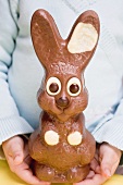 Child holding large chocolate Easter Bunny