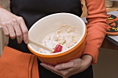 Woman stirring mixture in a baking bowl