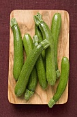 Several courgettes on chopping board