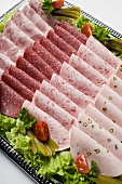 Cold cut platter garnished with gherkins (overhead view)