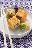 Inside-out rolls with soy sauce, ginger and wasabi