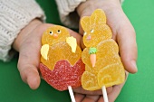 Child's hands holding jelly Easter Bunny and chick