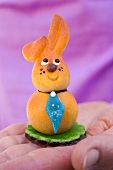 Hand holding marzipan Easter Bunny