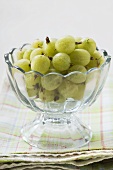 Gooseberries in glass pedestal bowl