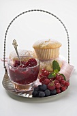 Berry jam, muffins and fresh berries on tray