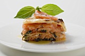 Portion of salmon lasagne with basil