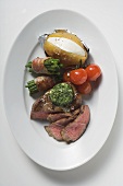Beef steak with herb butter and accompaniments