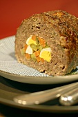 Meatloaf stuffed with egg, carrots and gherkins