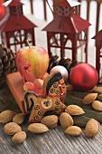 Gingerbread horse, almonds, apple, Christmas baubles, lanterns