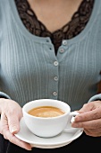 Woman holding cup of coffee