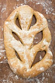 Ciabatta on wooden background with flour (overhead view)