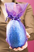 Woman holding large chocolate Easter egg
