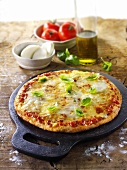 Tomato and mozzarella pizza with basil