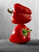 Two red peppers, one on top of the other