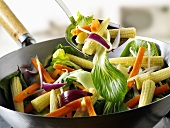 Vegetables and baby corn cobs in wok