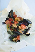 Mussels with tomatoes and saffron on parchment paper