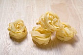 Tagliatelle on wooden background