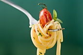 Spaghetti with cherry tomato on fork