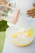 Adding flour to egg yolks