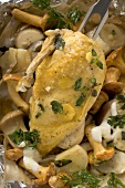 Chicken breast with mushrooms and herbs in aluminium foil