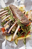 Rack of lamb with rosemary & vegetables on aluminium foil