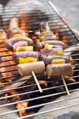 Sausage and pepper kebabs on barbecue