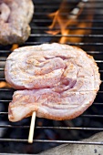 Pork on barbecue grill rack