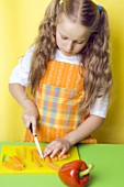Girl cutting up carrots