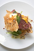 Beef fillet between sheets of pastry with basil and mango