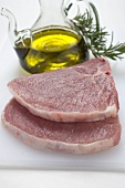 Two pork chops, olive oil, rosemary