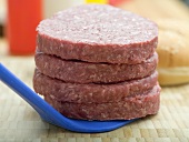 Four raw burgers for hamburgers