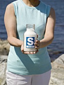 Woman holding jar of sea salt