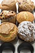 Assorted muffins in muffin tin (overhead view)